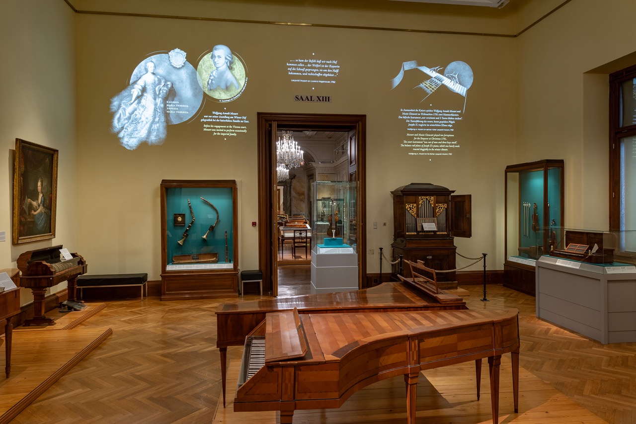 Room in Weltmuseum Wien with historical paintings and musical instruments display